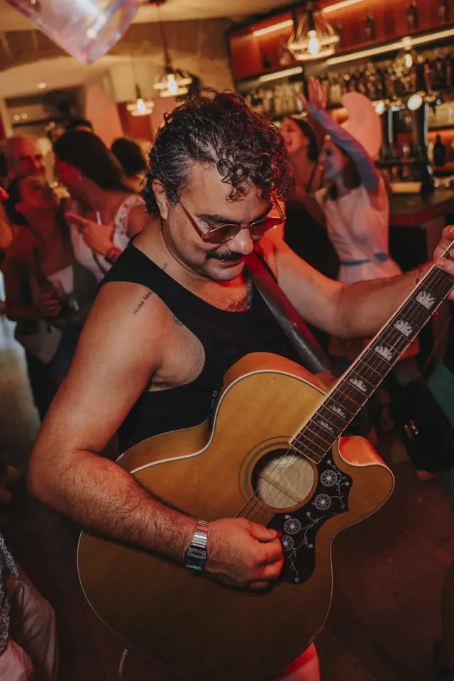 Un chico tocando la guitarra en la sala